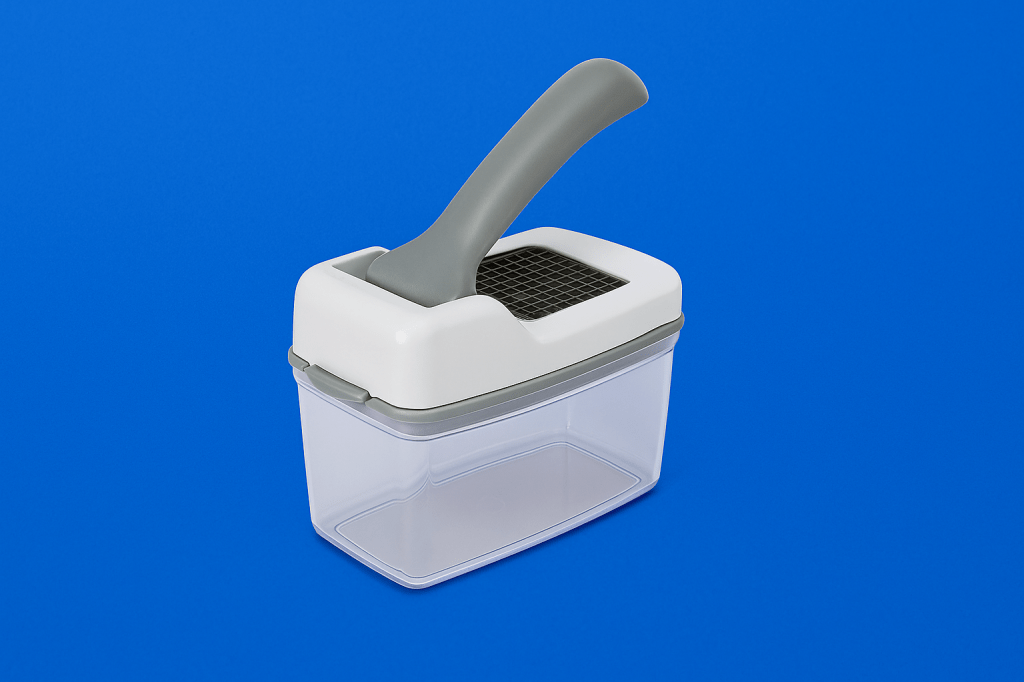 Manual vegetable chopper with gray handle and clear container on a royal blue background