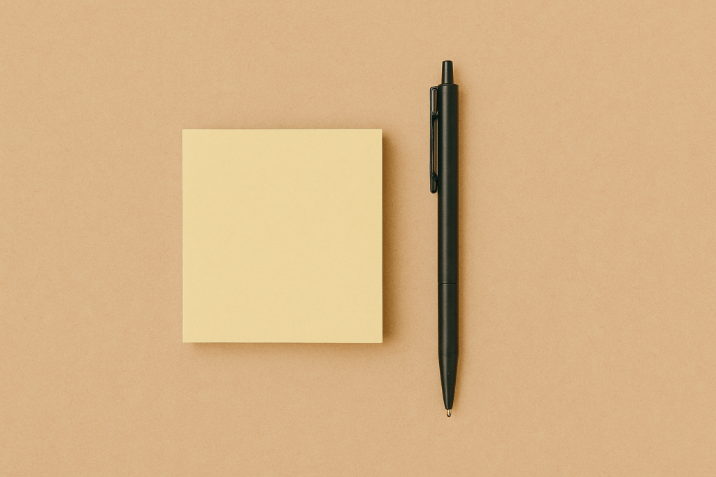 Stack of sticky notes and black pen on a beige background representing daily task prioritization and mindful planning