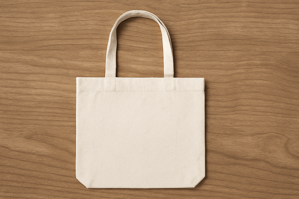 Beige reusable tote bag centered on a wood grain background