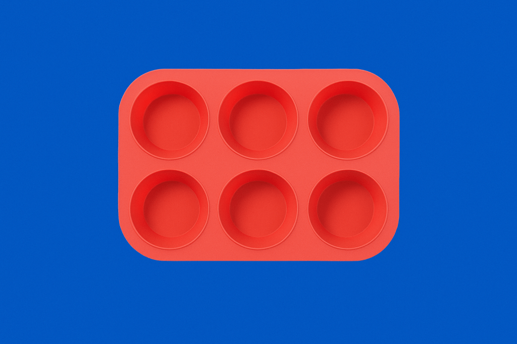 Red silicone six-cup muffin tray centered on a royal blue background